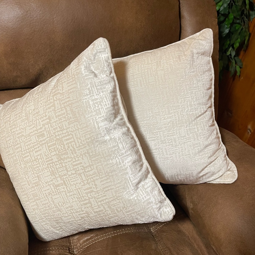Pair of cream colored throw pillows